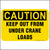 Caution keep our from under crane loads sign printed in yellow and black.