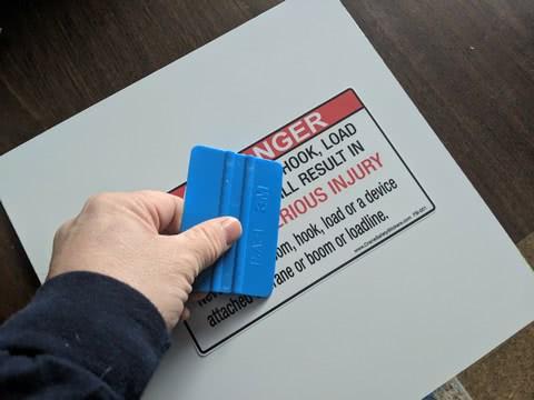 applying vinyl decals, graphics and Safety Stickers with a decal squeegee